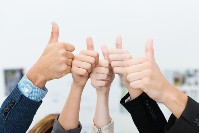 Successful diverse young business team giving a victorious thumbs up to show their success and motivation, close up view of their raised hands-1.jpeg